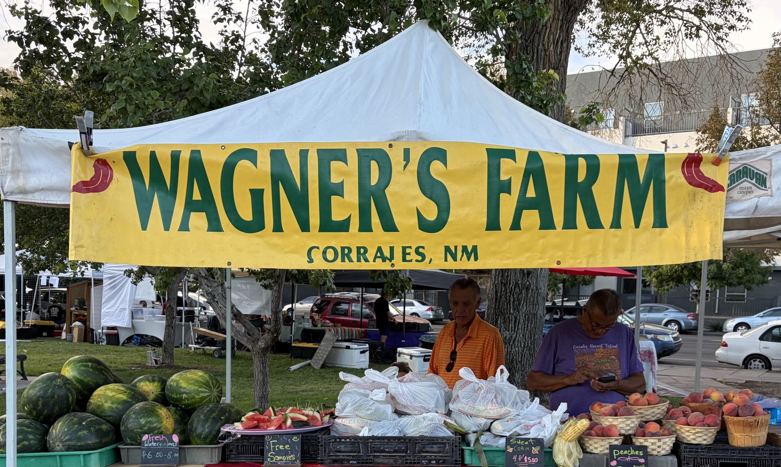 Wagner's Farm stand at the market, banner reading Wagner's Farm, Corrales NM